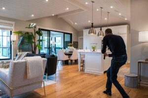 A couple discussing paperwork and finances at a kitchen table with a home purchase contract visible.